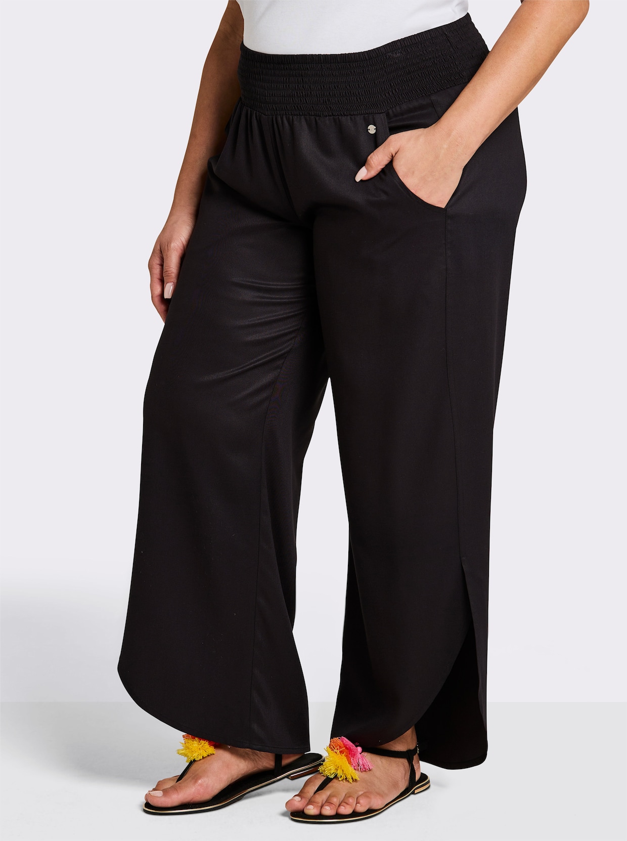 sheego Schlupfhose mit asymmetrischem Saum - schwarz