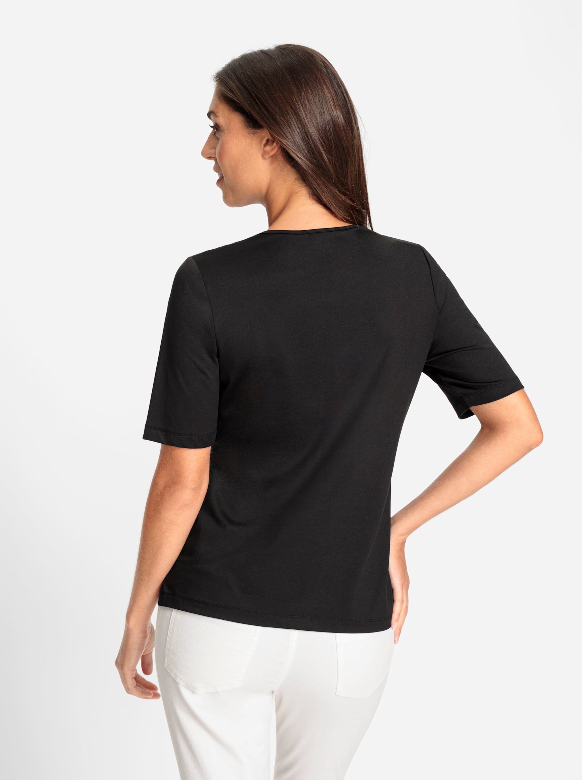 T Shirt  günstig Kaufen-Shirt in schwarz von heine. Shirt in schwarz von heine <![CDATA[Shirt Mit raffiniertem Cut-outs am Ausschnitt und etwas längerem Halbarm. Angenehme, knitterarme Tactel-Qualität. Figurbetonter Schnitt.]]>. 
