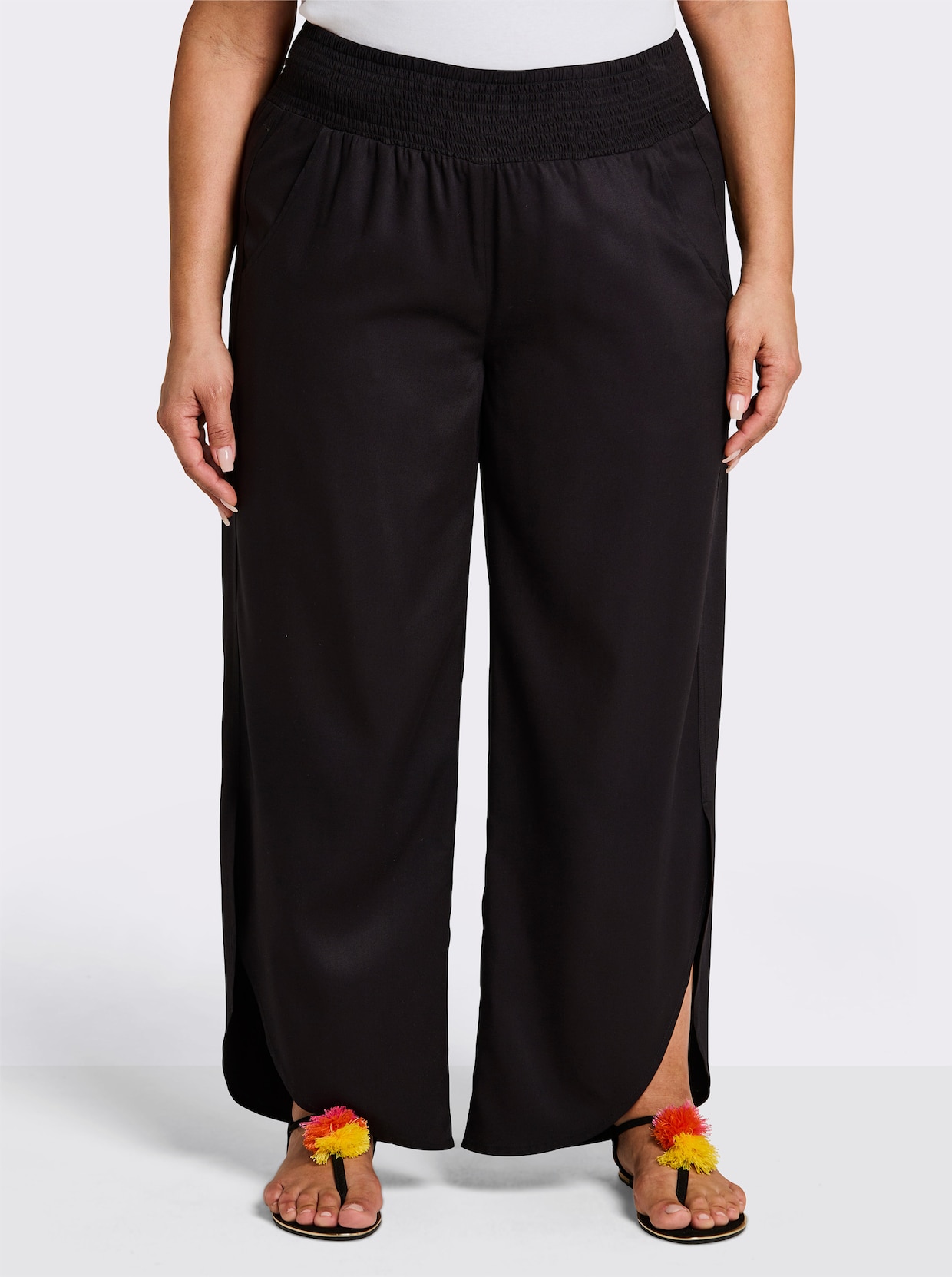 sheego Schlupfhose mit asymmetrischem Saum - schwarz