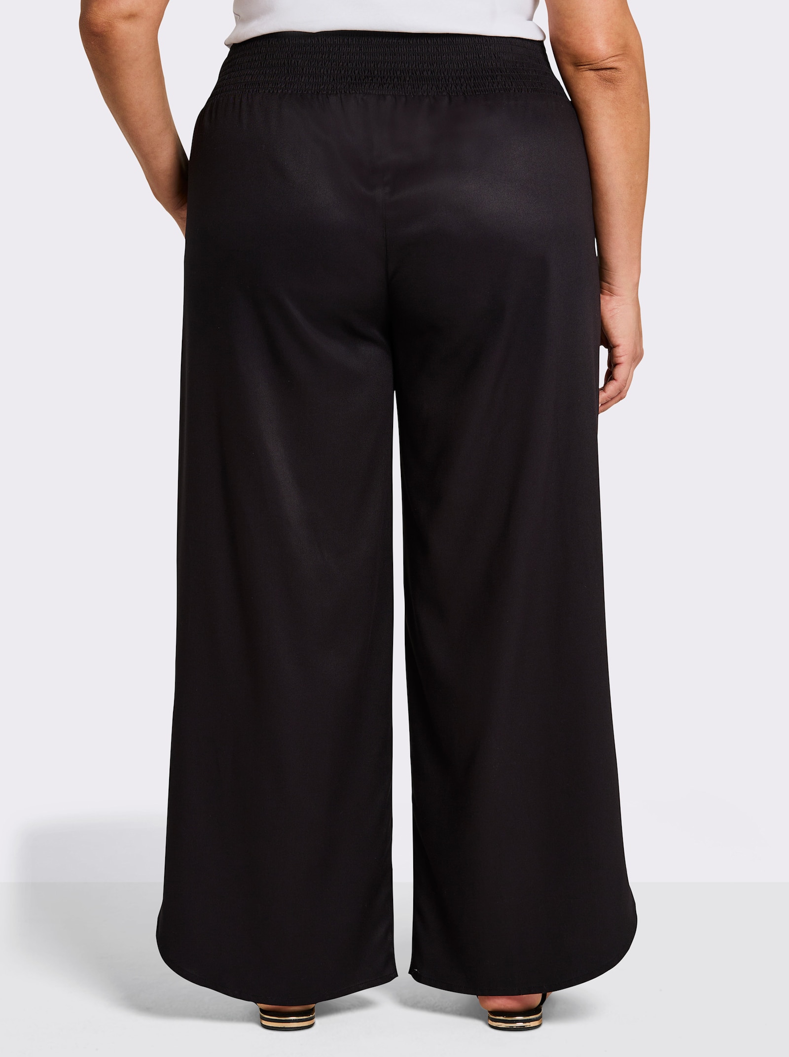 sheego Schlupfhose mit asymmetrischem Saum - schwarz