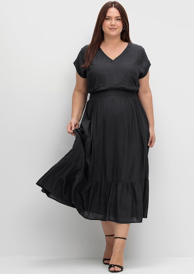sheego Maxikleid mit Smokbund und Volant am Saum - schwarz