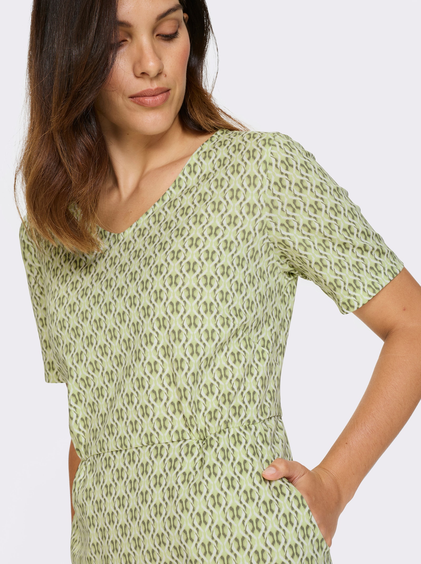 Jerseyjurk met zakken - pistache/kaki bedrukt