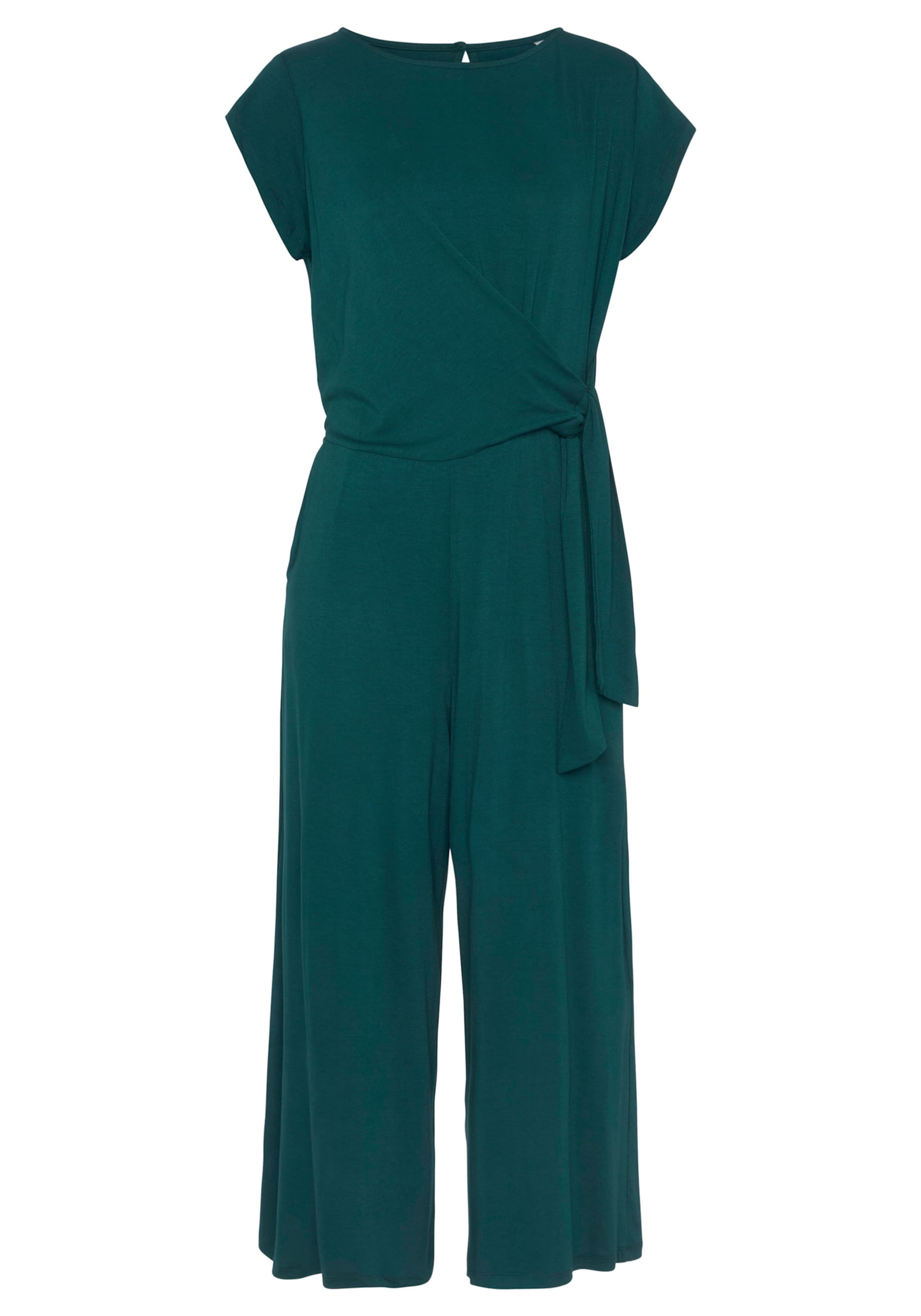 mm seitliche günstig Kaufen-Culotte-Overall in petrol von LASCANA. Culotte-Overall in petrol von LASCANA <![CDATA[Jumpsuit von Lascana mit taillierendem Knotendetail. Runder Ausschnitt mit Knopfverschluss hinten. Kurze Ärmel. Gummizug auf Taillenhöhe. Seitliche Eingrifftaschen. Au