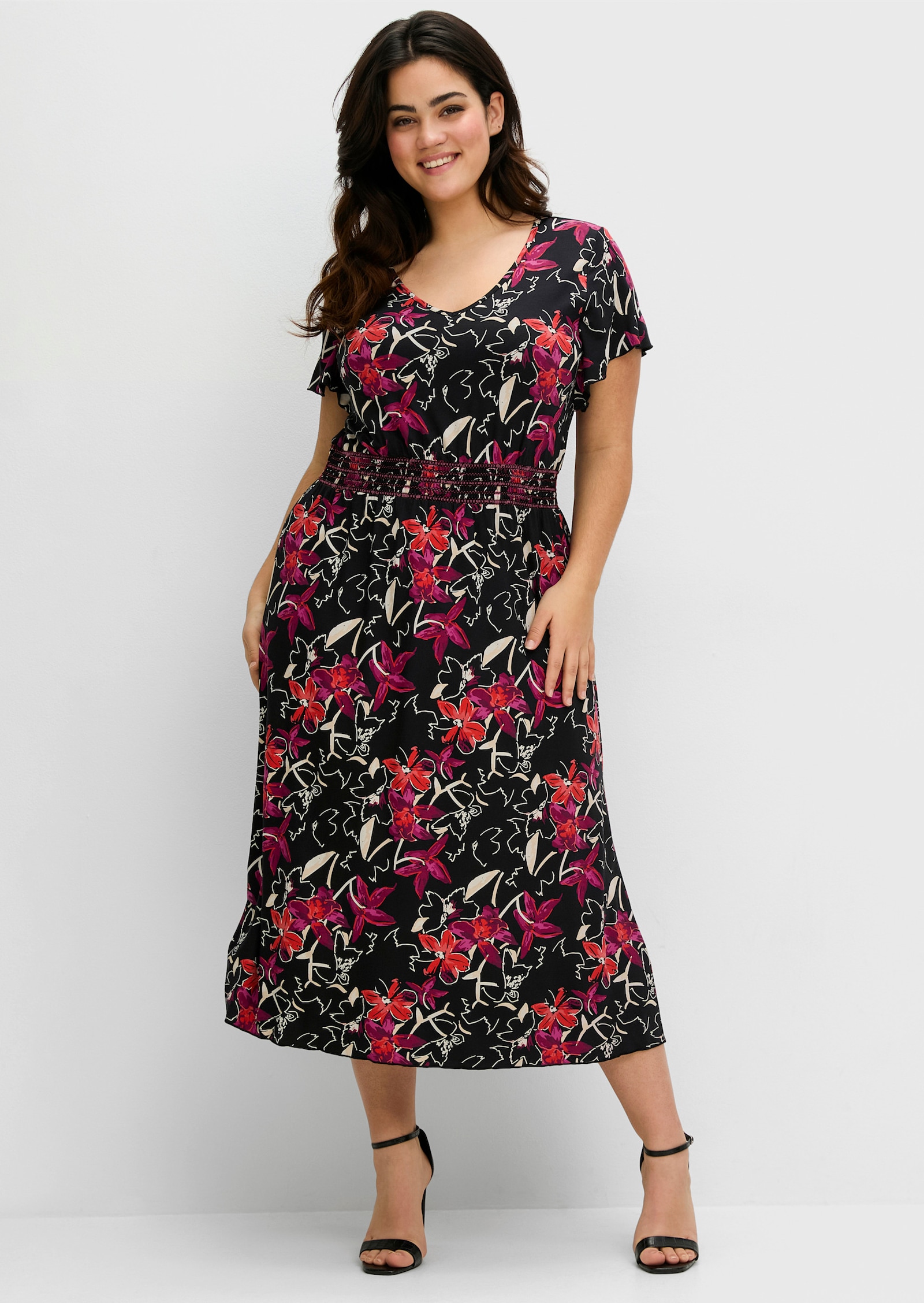 sheego Jerseykleid mit Zierbändern im Rücken. - schwarz bedruckt