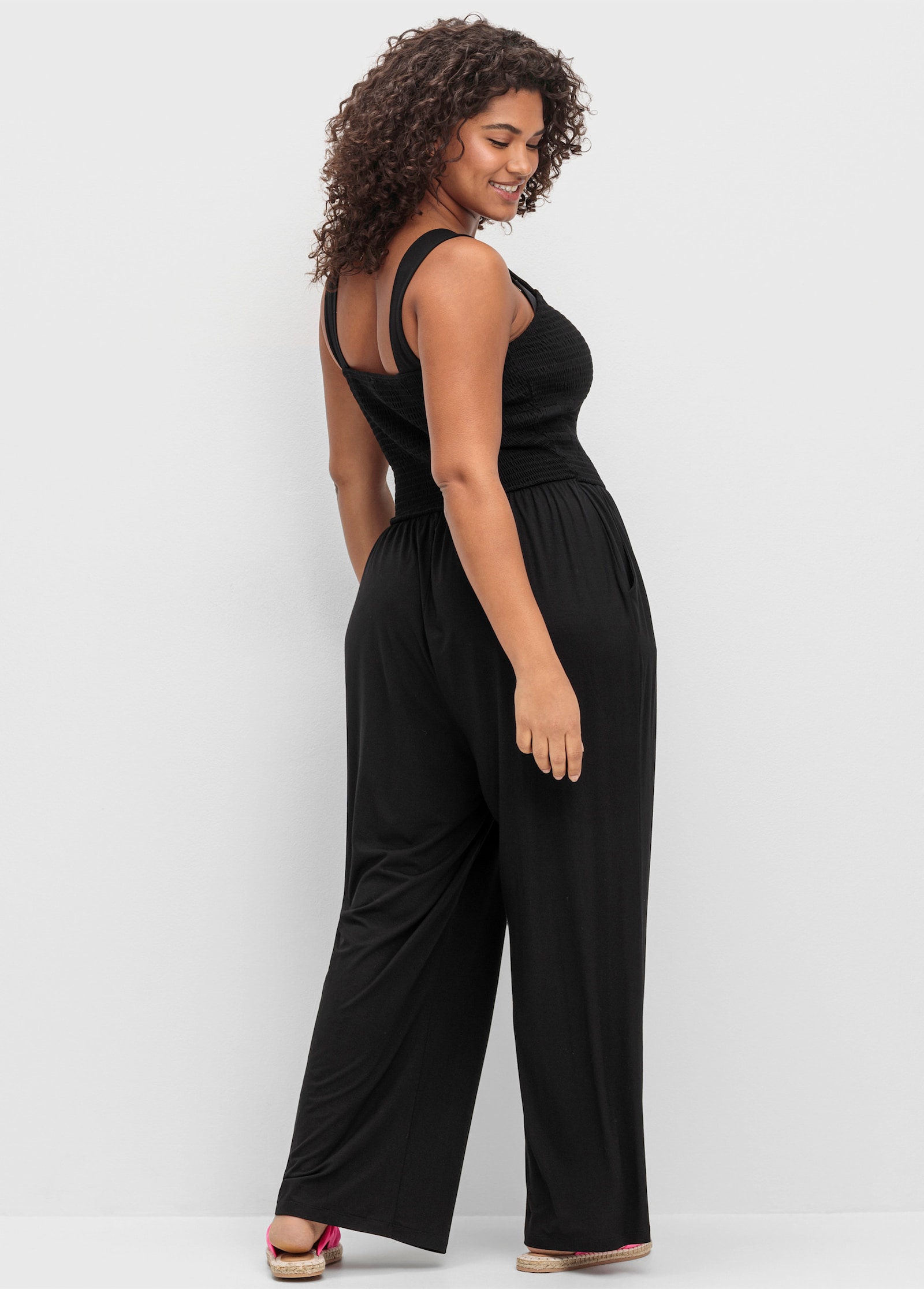 sheego Jumpsuit mit Smok-Oberteil und weitem Bein - schwarz