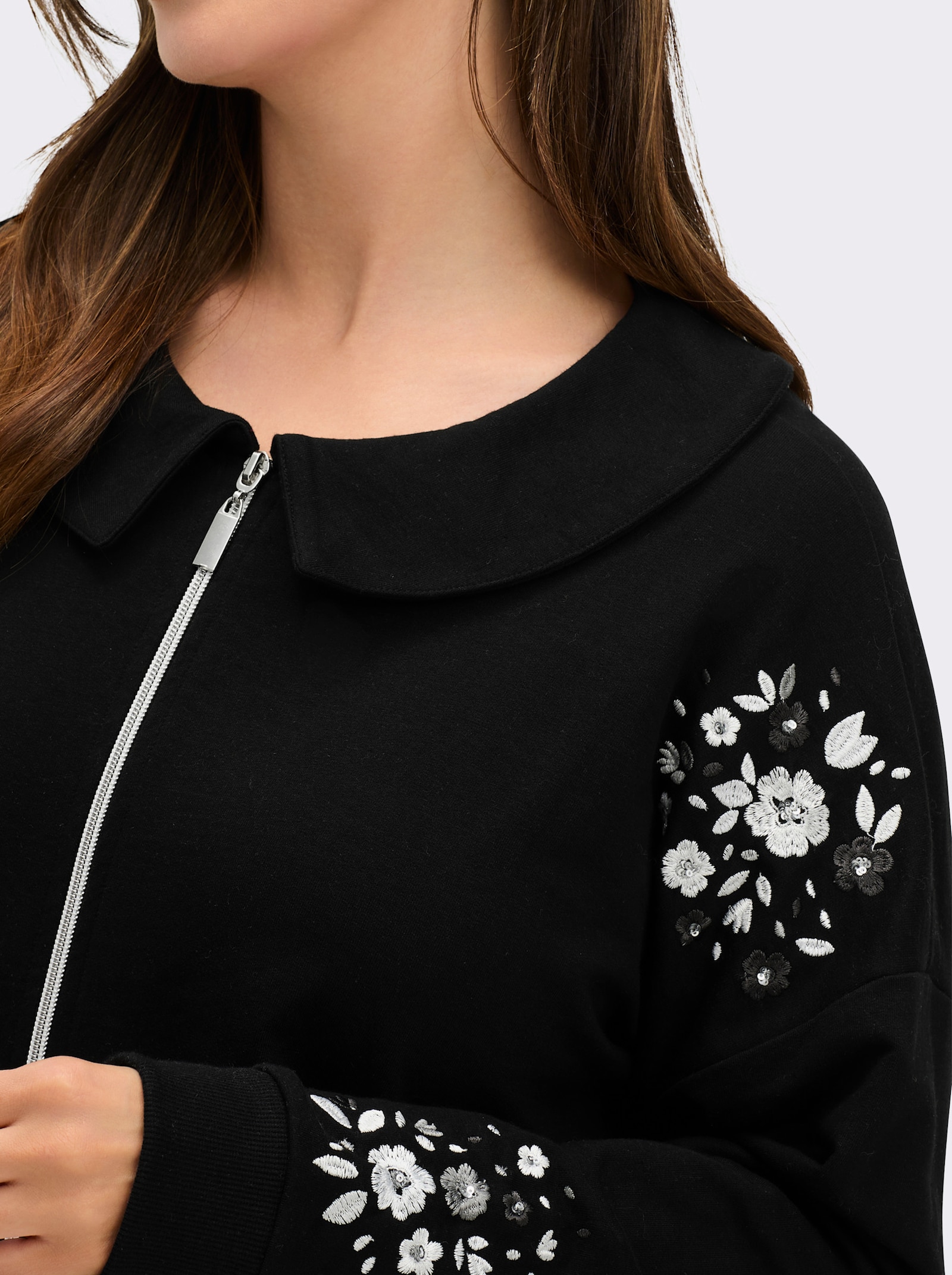 sheego Sweatjacke mit Glitzer-Blumendruck - schwarz