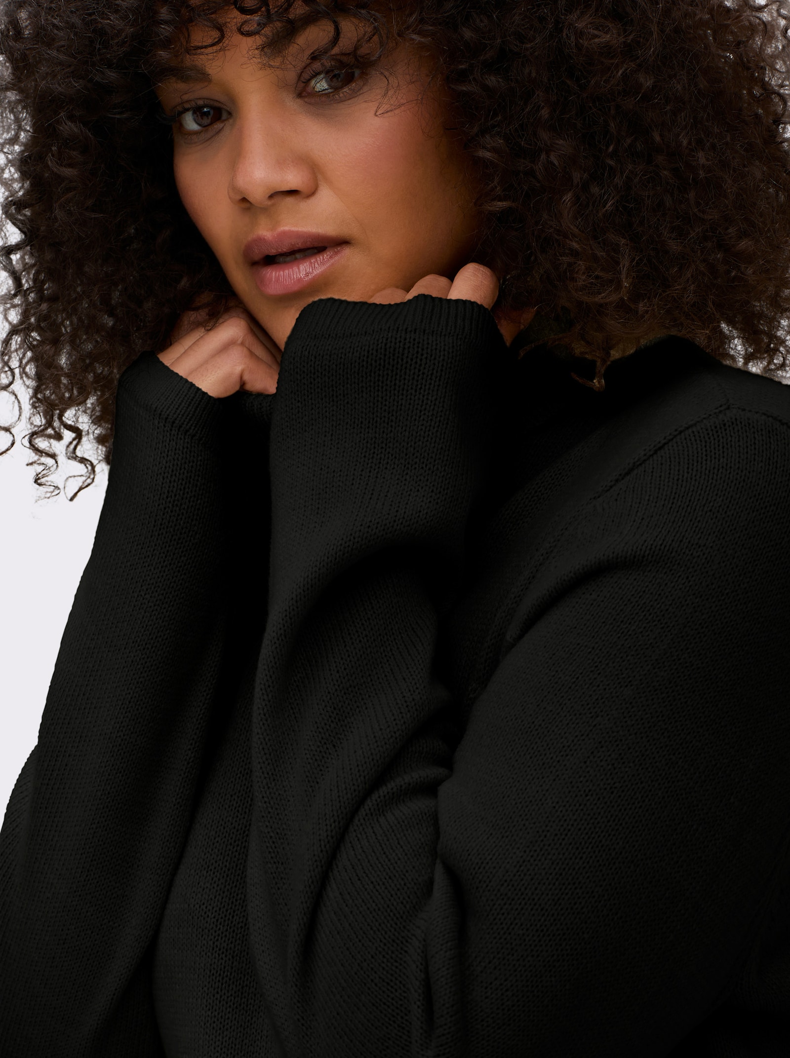 sheego Rollkragenpullover in A-Linie - schwarz